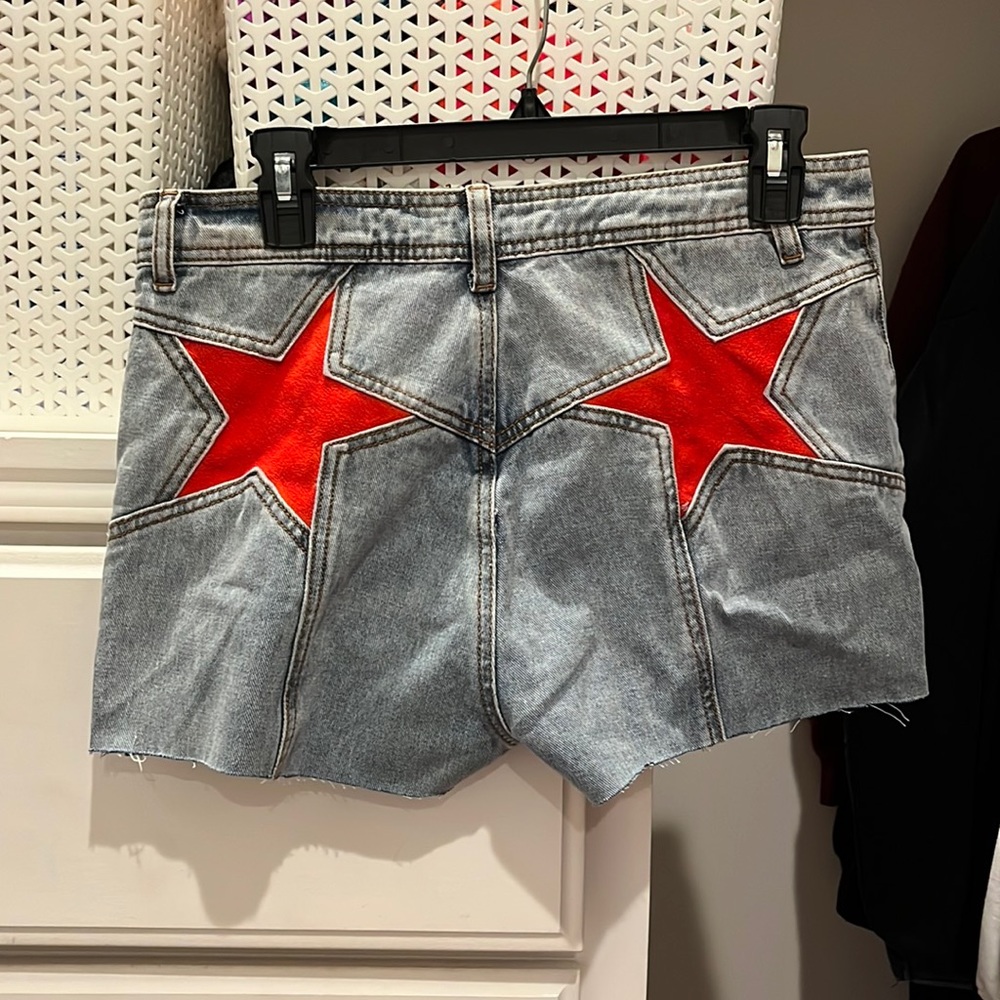 light wash denim shorts with red stars on the back